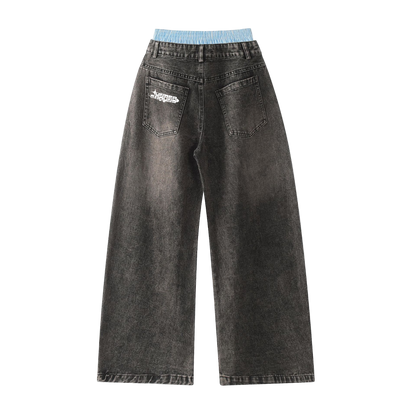 Black jeans with a brand logo on the back pocket against a white background